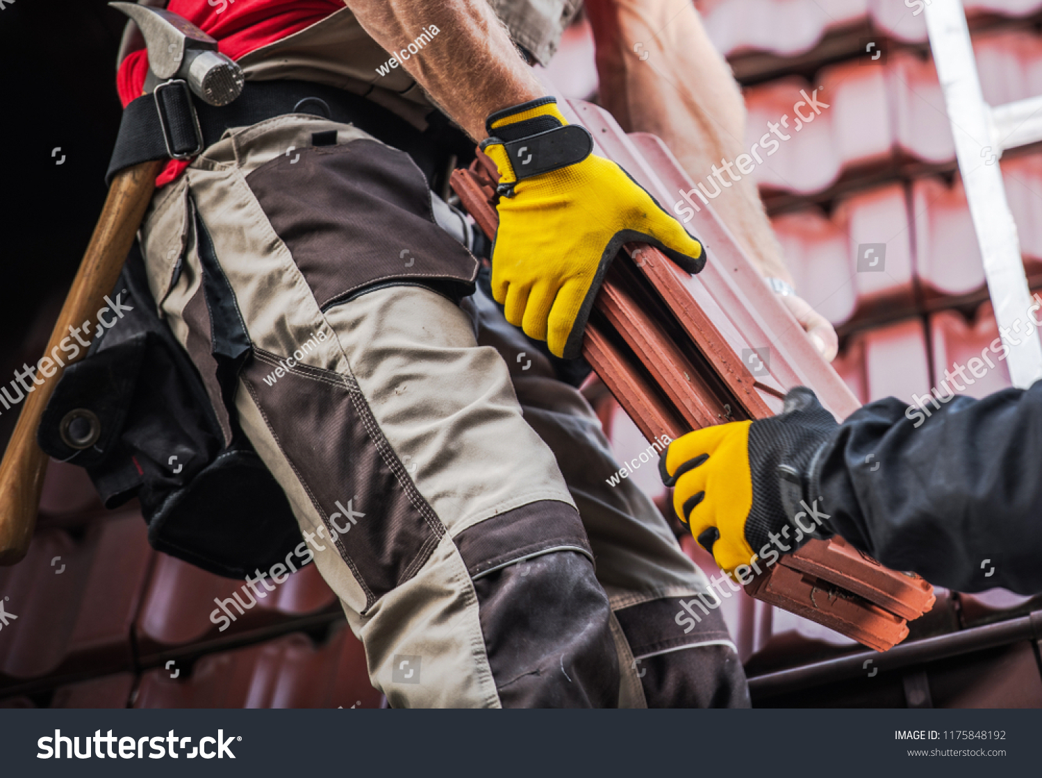 stock-photo-ceramic-roof-tiles-installation-by-two-caucasian-roofers-construction-industry-1175848192